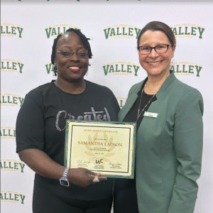 Scholarship recipient Samantha Ladson receives her recognition certificate from LAVC Foundation Director Andrea Schmitt.