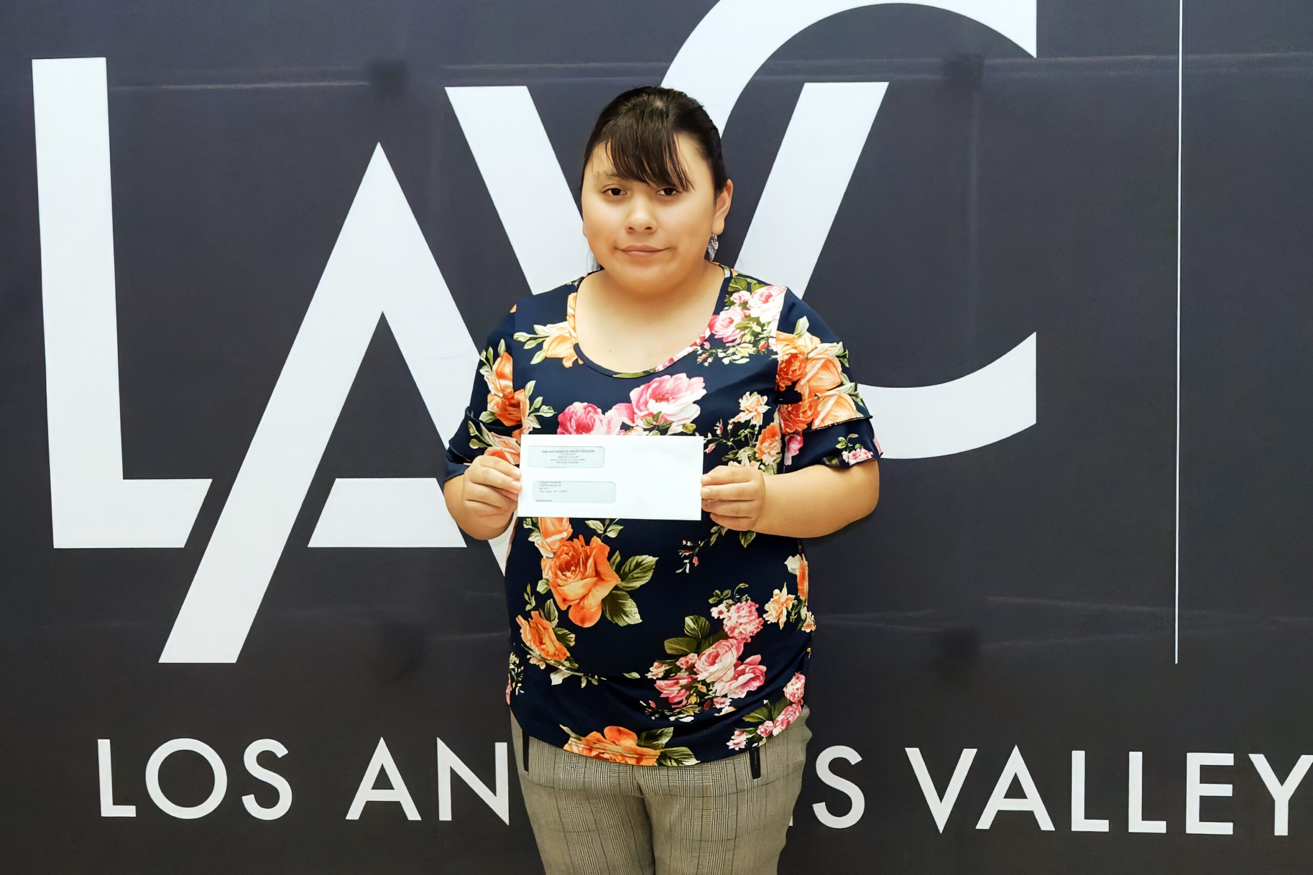 Lizbeth Resendiz with scholarship.